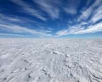 Antarctic melting slows atmospheric warming and speeds sea level rise