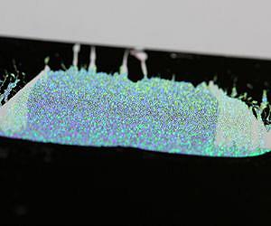 A layer of tiny grains can slow sound waves