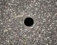 Hubble Helps Find Smallest Galaxy Containing Supermassive Black Hole