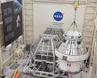 Preparing to test Orion spacecraft requires a big plane, huge cranes and a vacuum cleaner