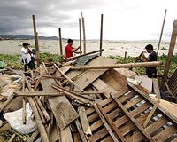 Philippines cleans up after latest typhoon kills 14