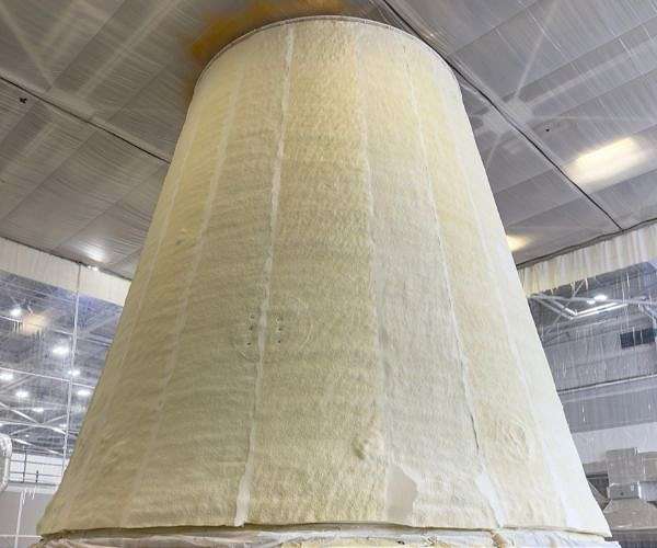 Technicians apply thermal protection material to SLS