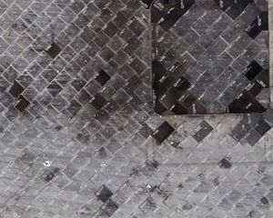 Astronauts inspect damaged tiles on shuttle